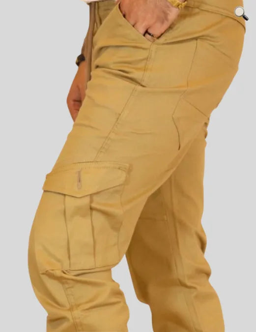 Close-up of mustard yellow cargo pants on a plain background