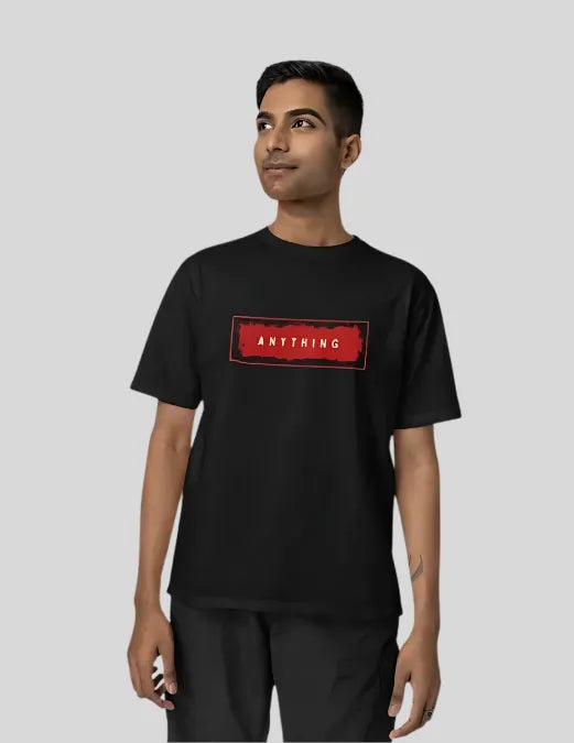 Person wearing a black t-shirt with a red logo and text on a plain background