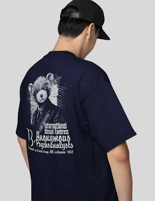 Person wearing a navy blue t-shirt with a graphic design on the back, featuring text and a bear illustration.