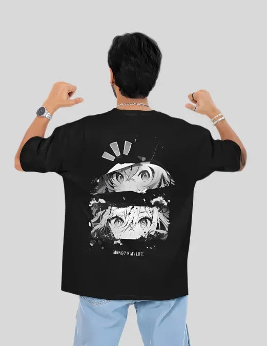 Person wearing a black t-shirt with anime design on the back, standing against a plain background