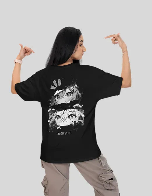 Person wearing a black t-shirt with graphic design on the back, pointing at the design.