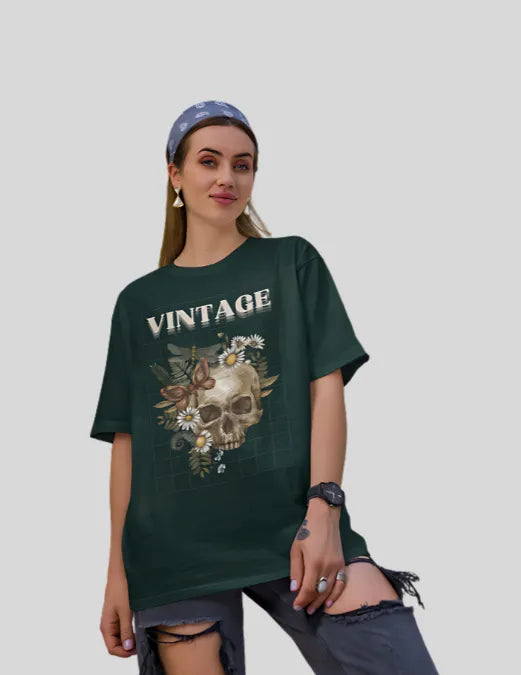 Woman wearing a dark green t-shirt with a skull and floral design and the word 'Vintage'.