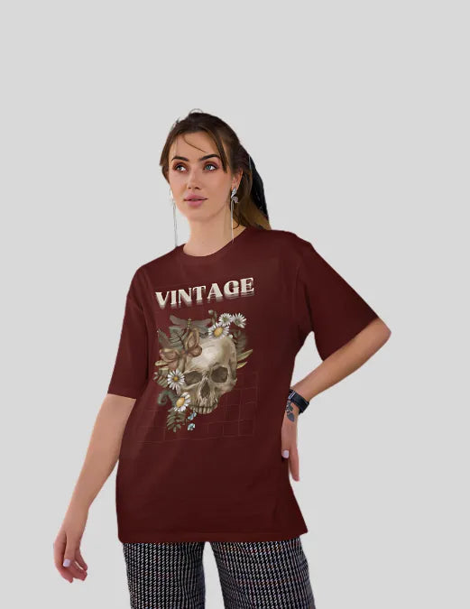 Woman wearing a maroon t-shirt with a skull design and 'VINTAGE' text on a plain background